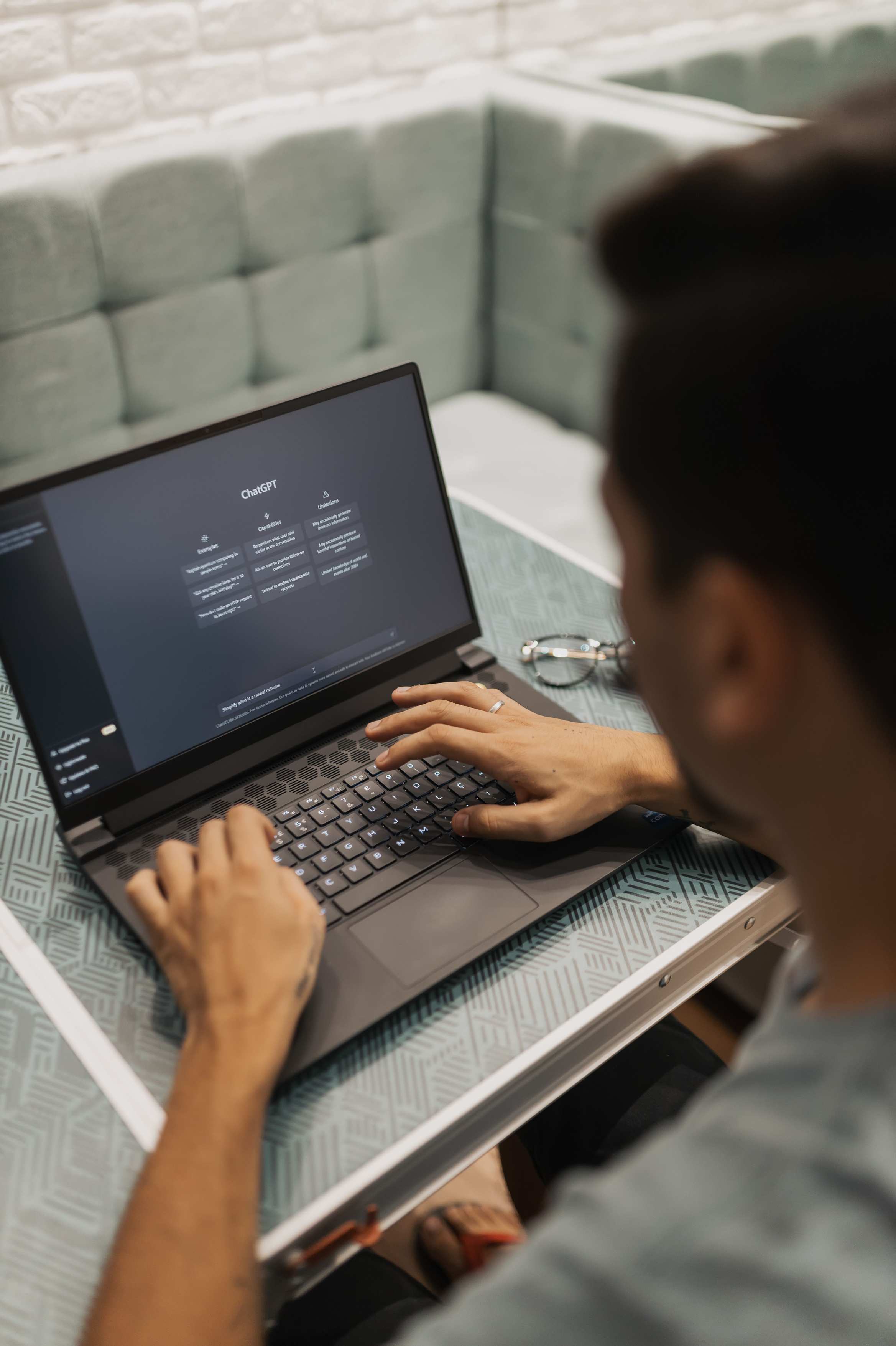 Close view of a laptop keyboard and screen while coding in a modern setting